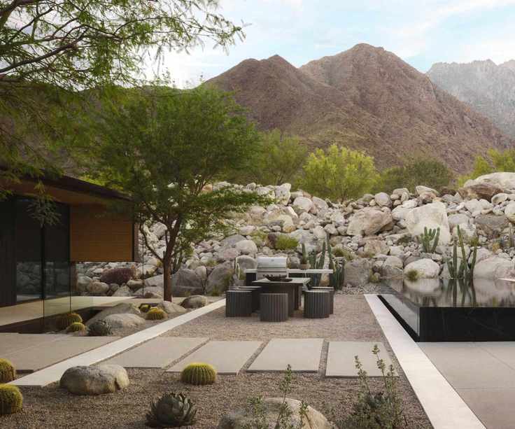 desert modernist design with boulders, gravel, plants and outdoor furniture