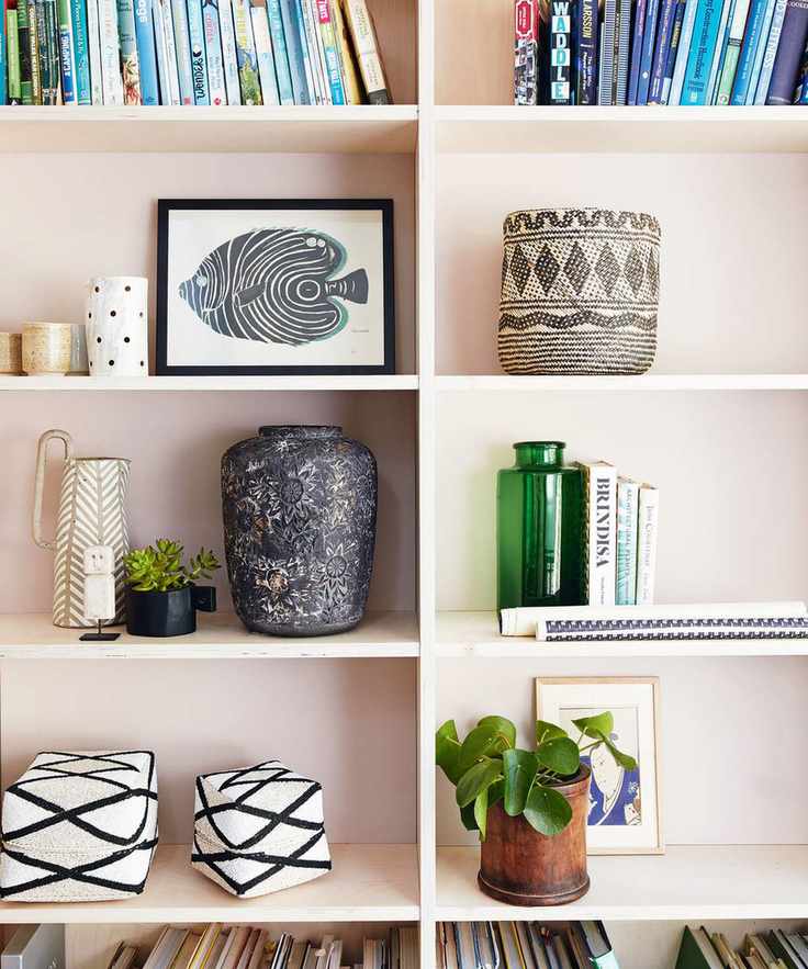 pink shelving with decorative objects and books