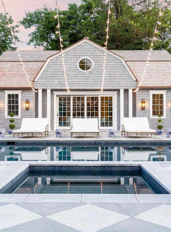 Pool with sunloungers and house