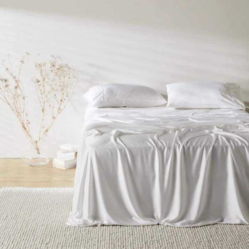 Bamboo Signature Sateen Sheet Set on a bed against a white wall.