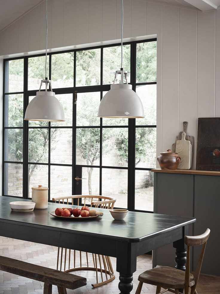 dining room with shiplap walls, long dining table, bench, chairs, two enamel white pendant lights