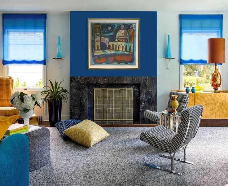 Mid-century modern living room with blue curtains and blue feature wall