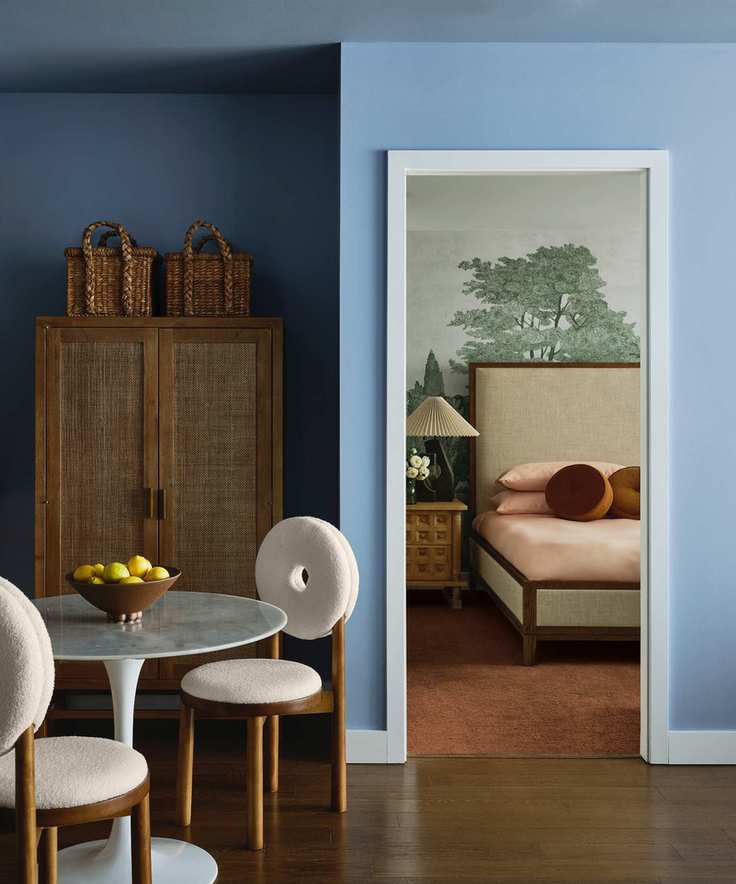 best blue paint, blue dining room with bedroom in background, hardwood floor, cabinet with baskets two dining chairs