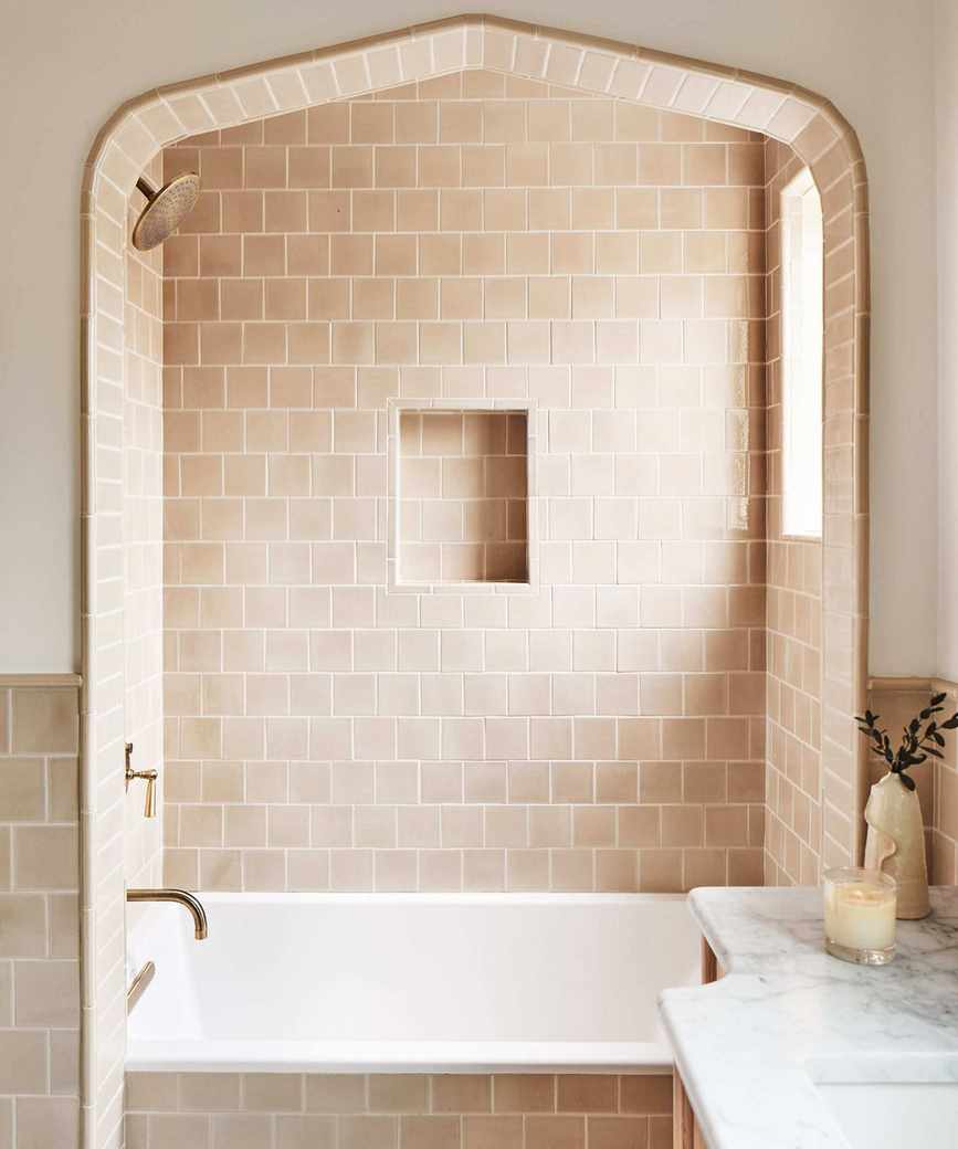 Warm neutral bathroom with soft white walls and beige square tiles