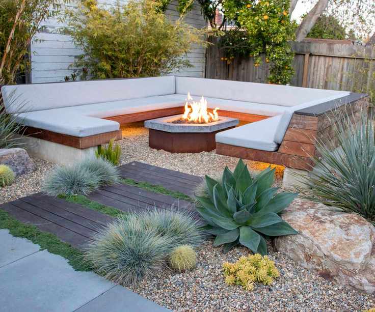 gravel garden with outdoor sofa and fire pit