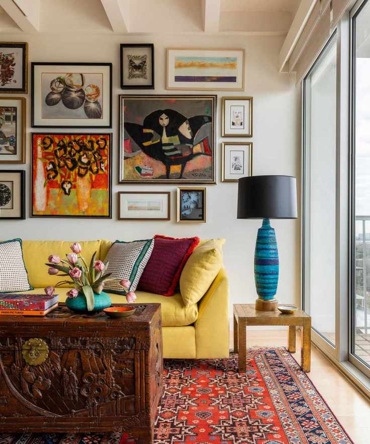 yellow sofa with gallery wall and vintage rug with modern lamp
