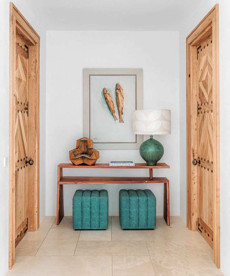 Modern entryway showcasing unique art and console