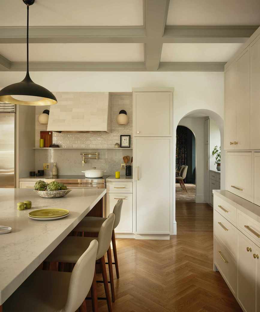 off-white kitchen with wood herringbone floors