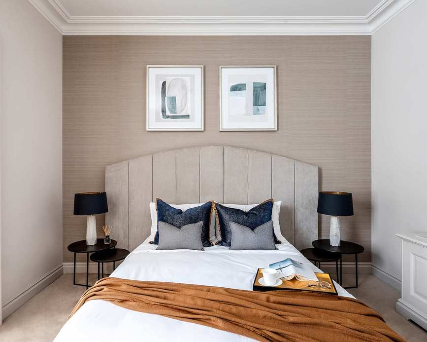 Warm brown-grey walls with taupe headboard