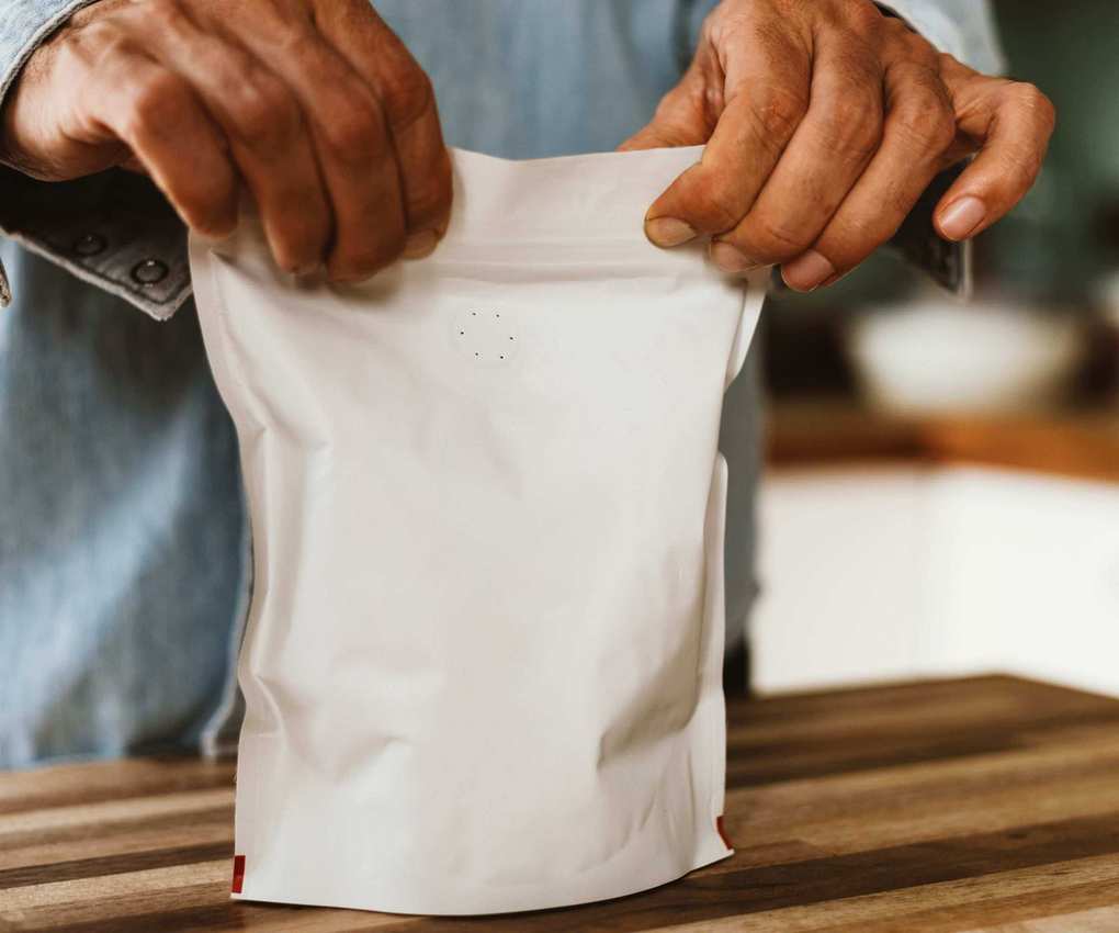 A bag of coffee beans being sealed