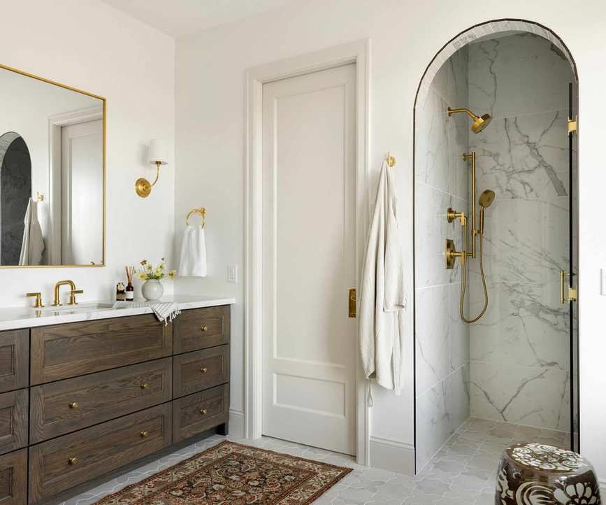 A neutral guest bathroom with warm white walls