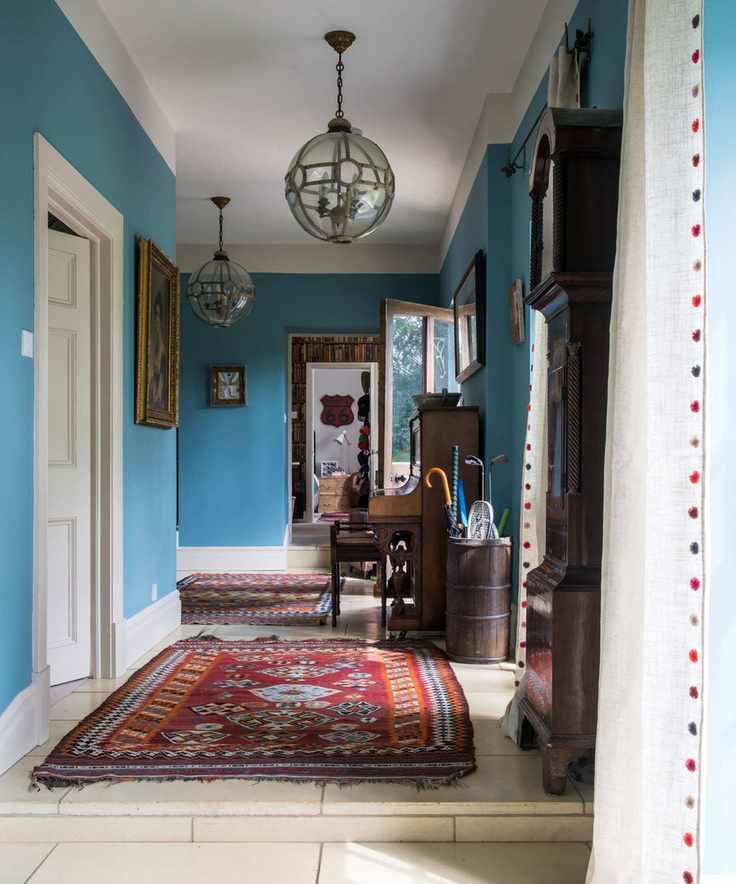 Traditional hallway with stone flooring and blue walls