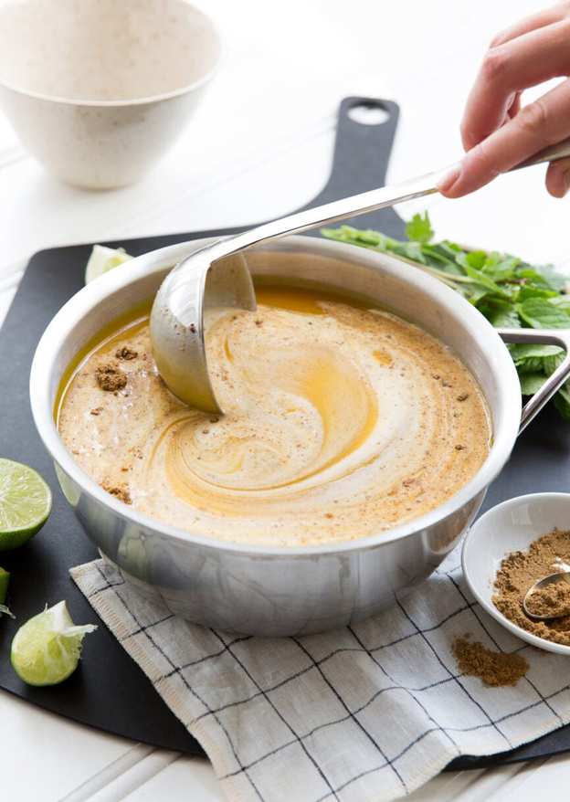 stirring pumpkin soup