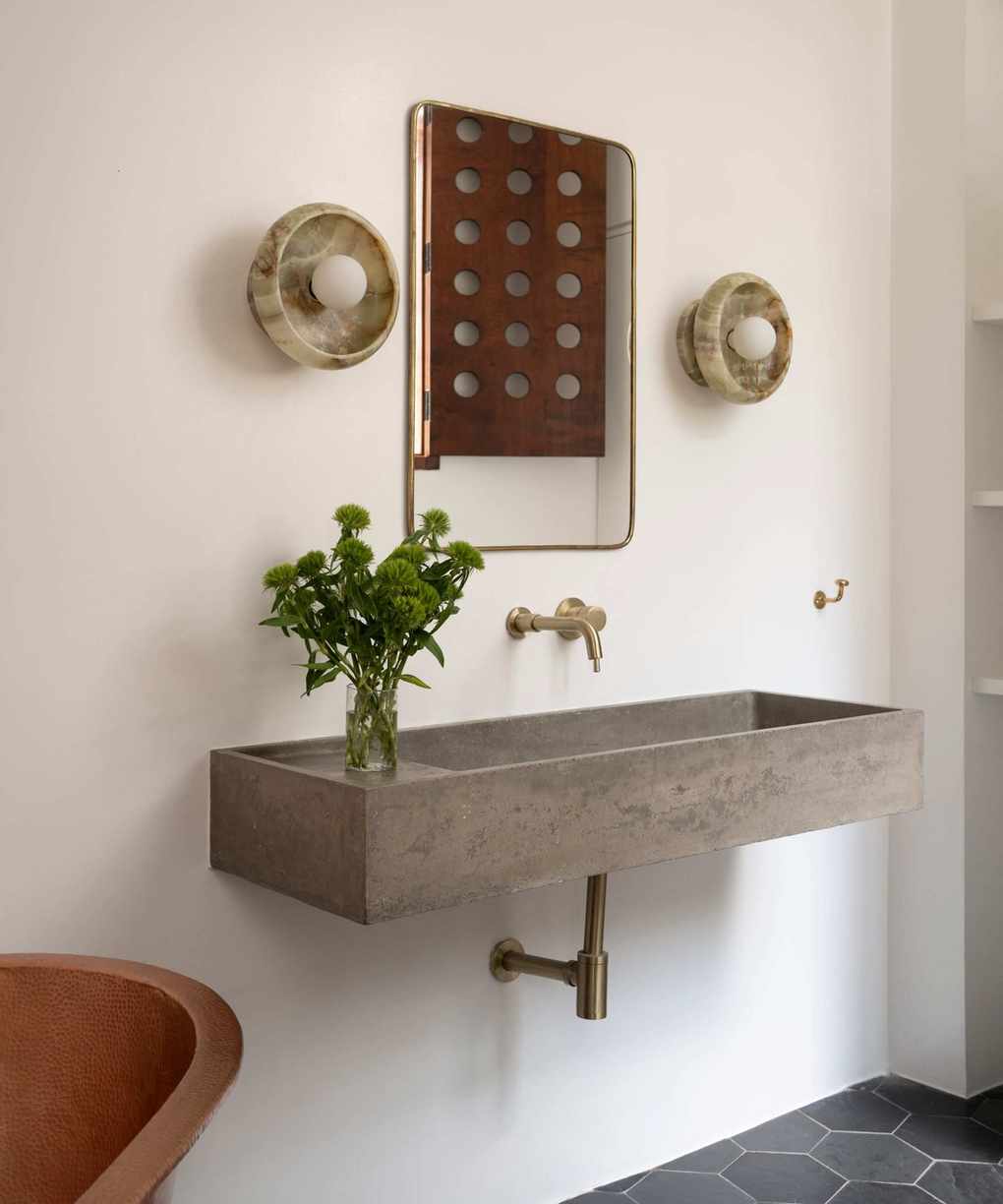floating stone basin in bathroom with white walls