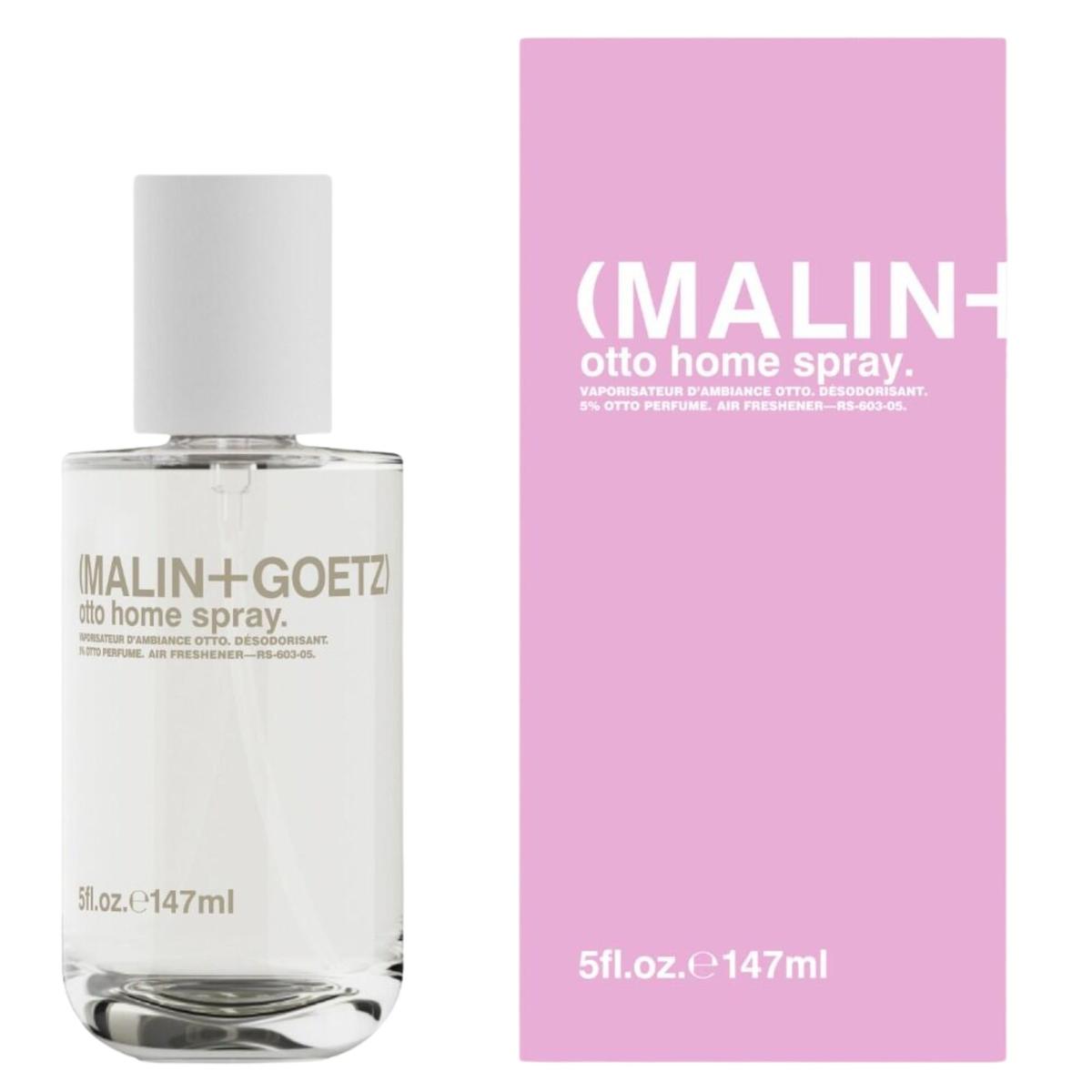 A glass bottle of Malin+Goetz room spray next to a baby pink cardboard packaging box