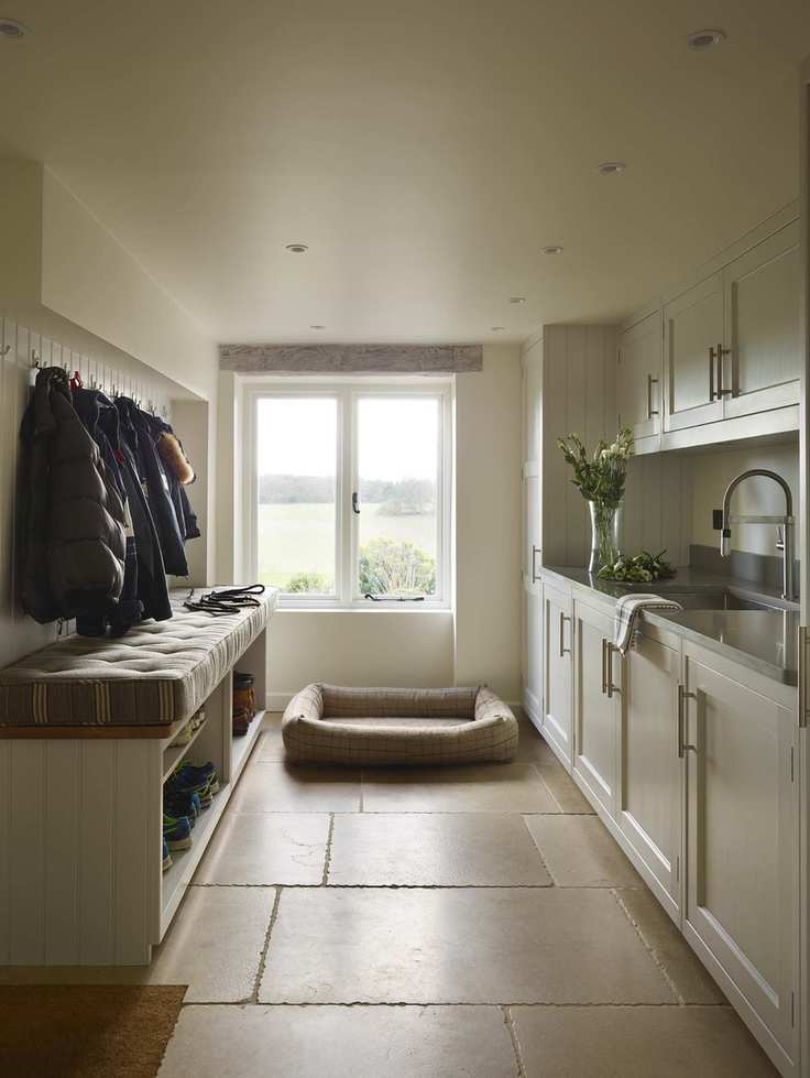 Utility room in neutral shades with a bench and sink