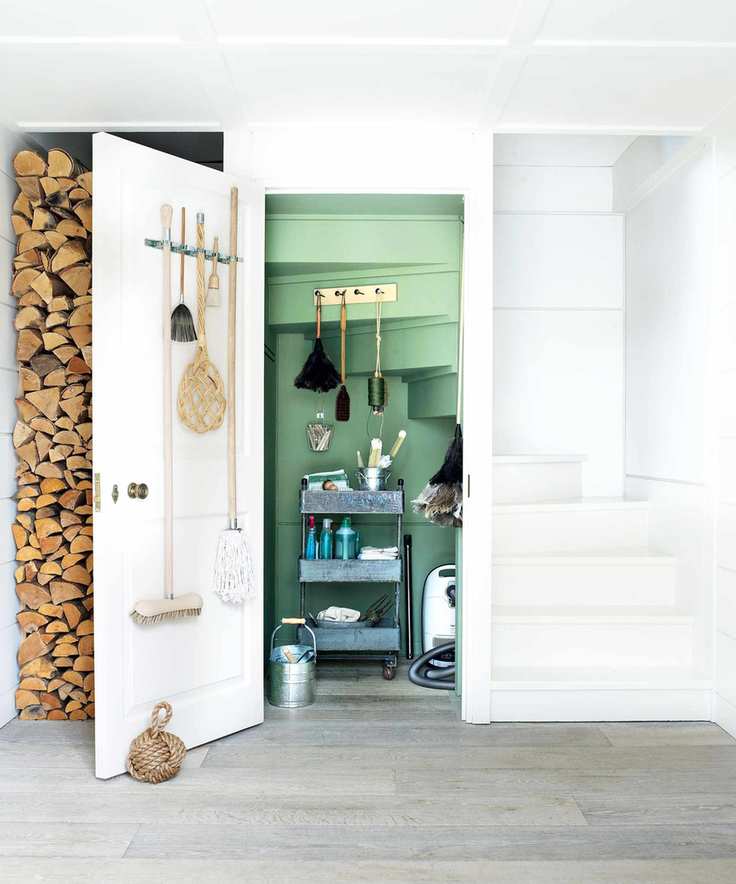 cleaning closet with hooks and trolley for storage