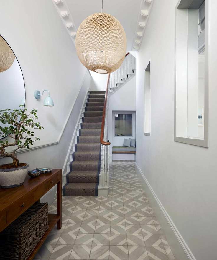 Hallway with gray tiled floor and decorative coved ceiling