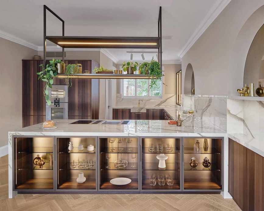 Large kitchen with kitchen island, storage in base, large ceiling light suspended over island, marble countertop