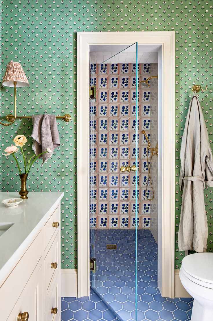 Bright bathroom with blue hexagon floor and pink wall tiles