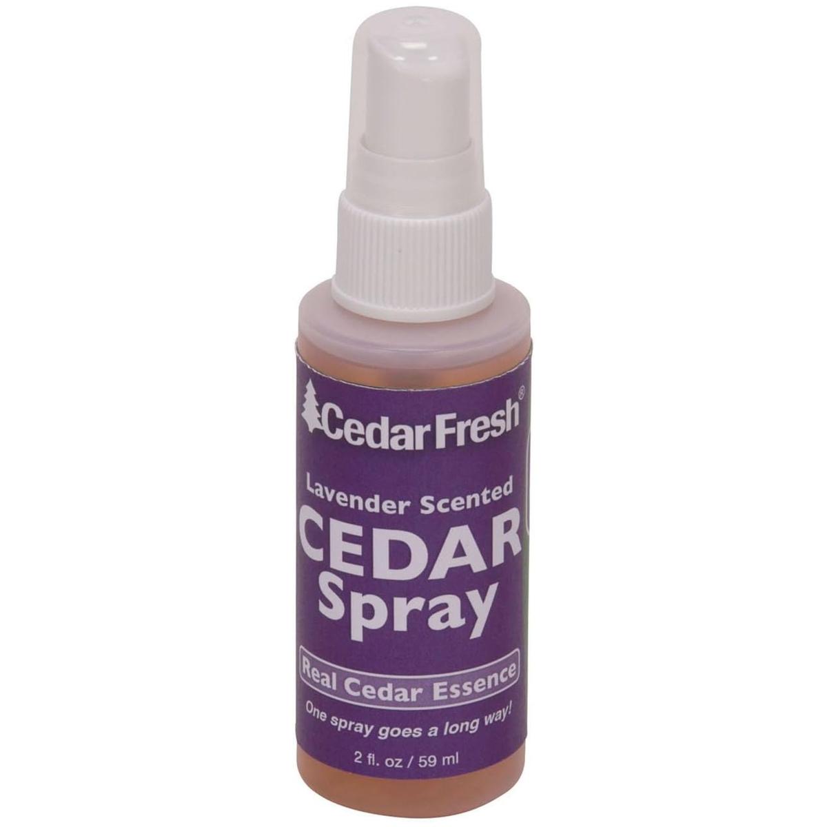 A bottle of cedar spray with a purple label and white spray lid