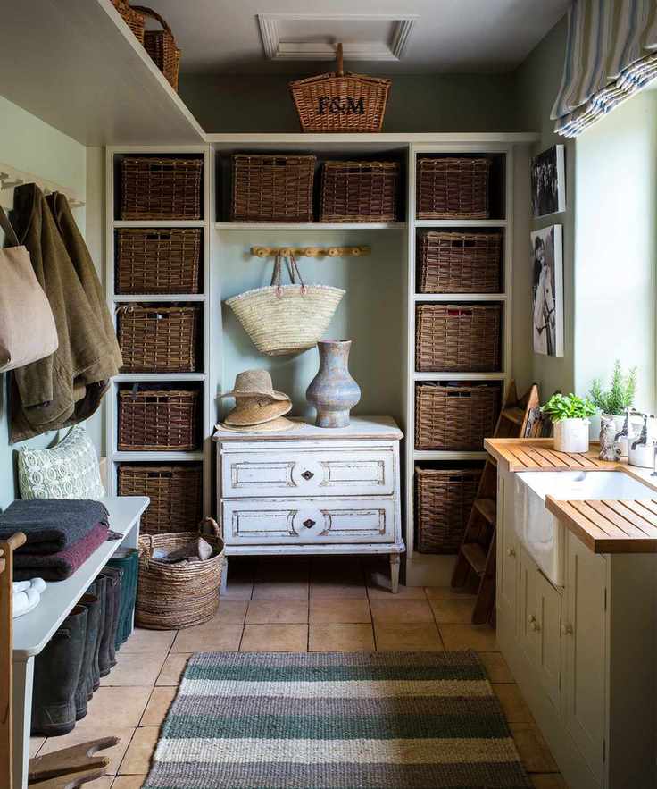 Boot room, with wicker storage baskets in tall shelving units