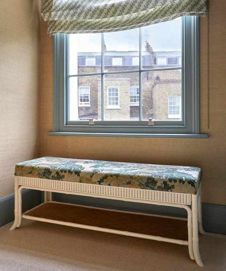 A hallway decorated with a reupholstered bench with antique textiles