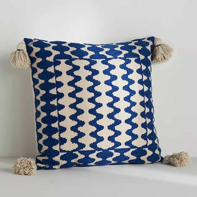 blue patterned pillow with tassels