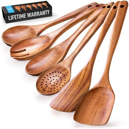A set of six wooden kitchen utensils fanned out in front of a black wooden box.