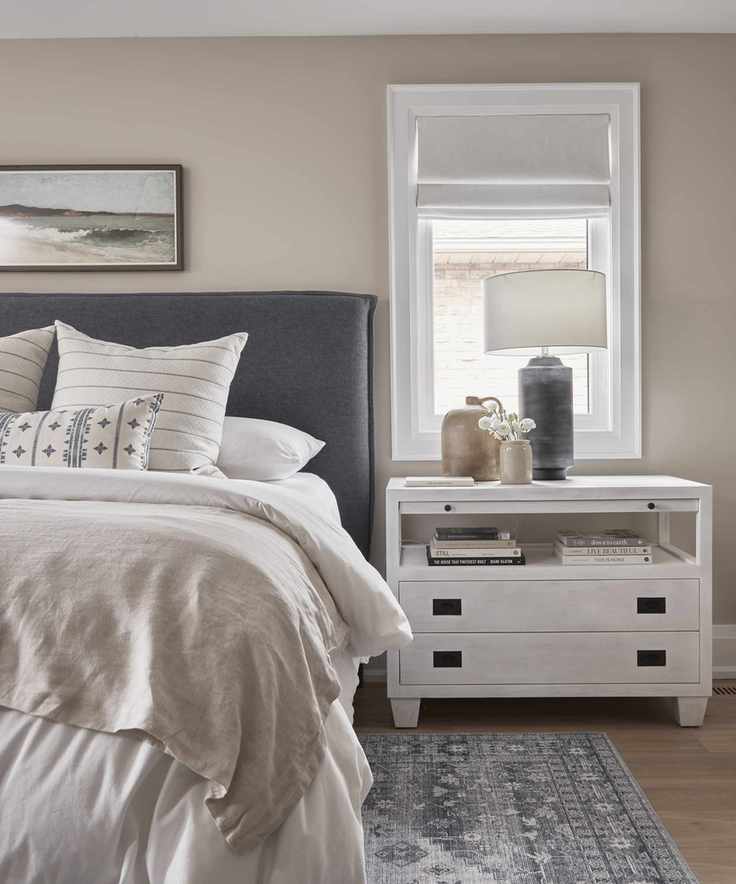A grey bedroom with blue accents