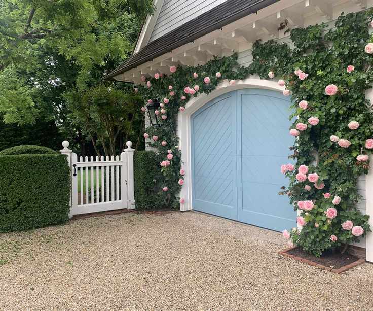 garage and gate with roses in front yard