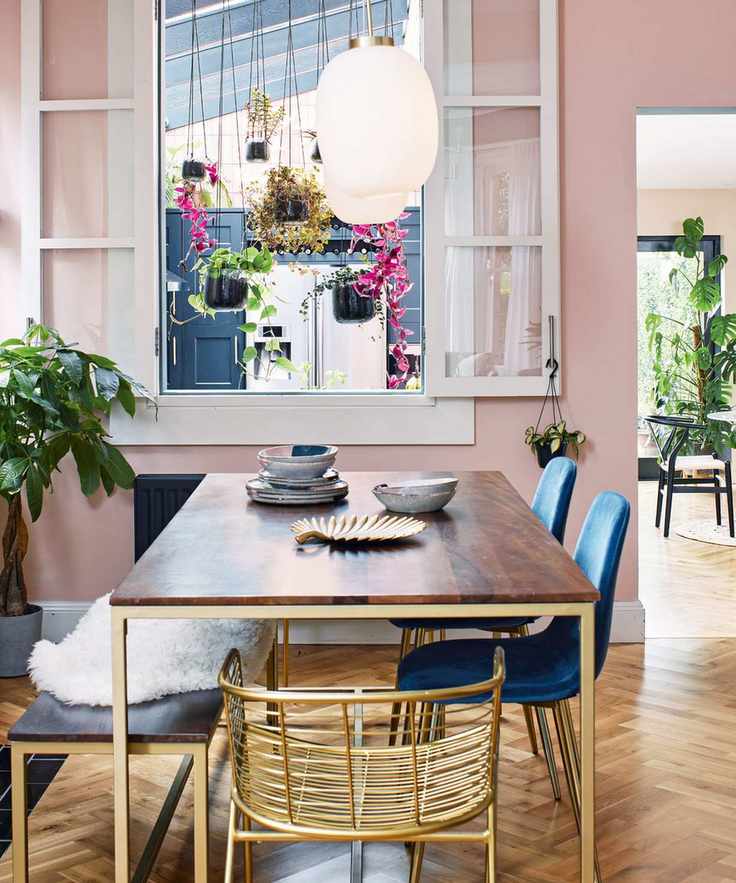 Dining room painted in playful pink with contemporary elements