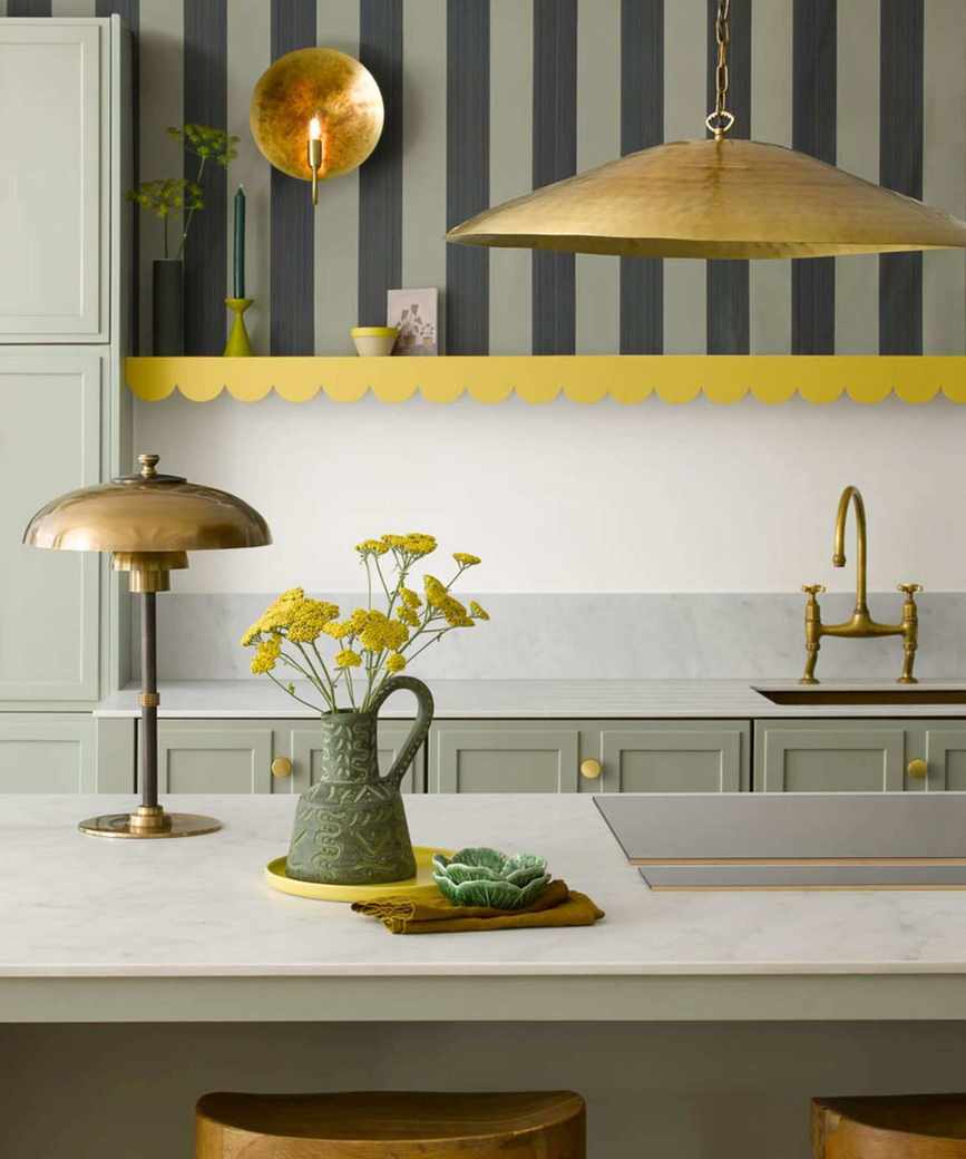 A white and green kitchen with textured metal lighting