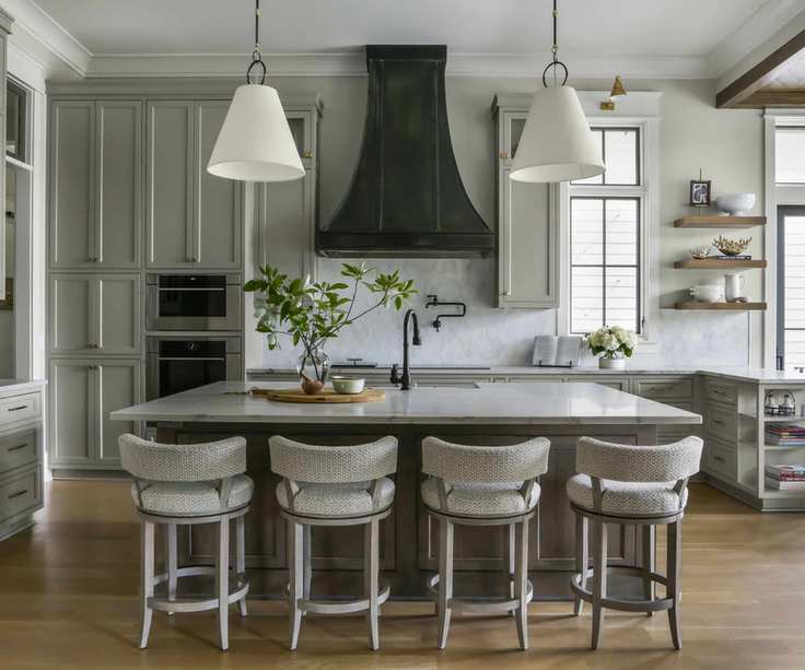 kitchen island with four stools and cooker hood behind