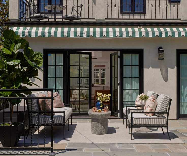 outdoor seating area with sofas and balcony above