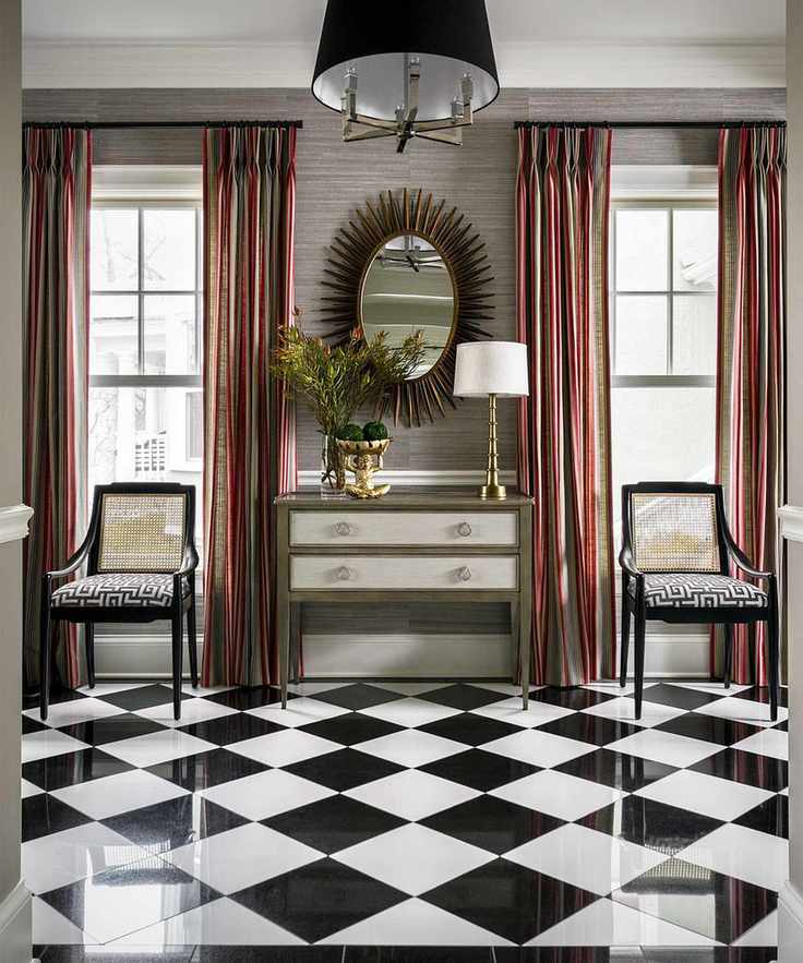 A foyer with checkered flooring and stylish decor