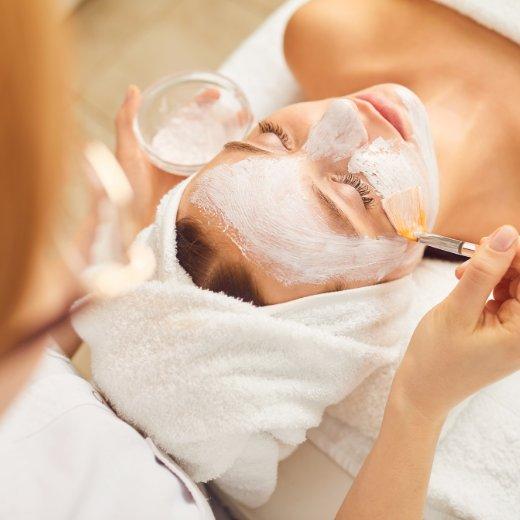 Woman receiving professional skincare treatment facial