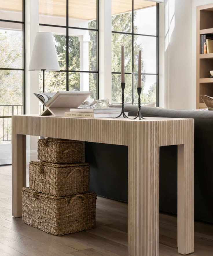 Baskets underneath console table in living room