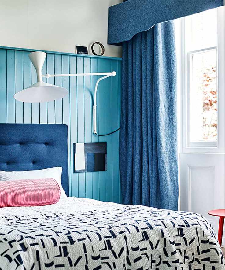 Bedroom paint ideas with blue painted panelling blue curtains and pin cushion on bed