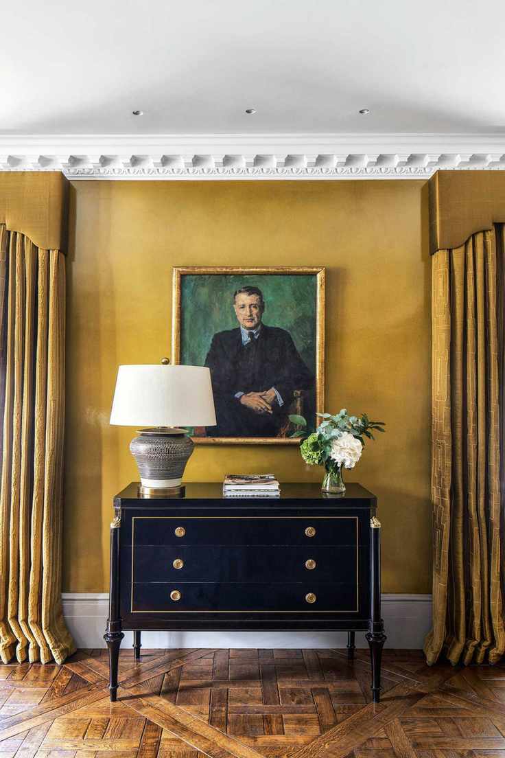 Curtains in a yellow room with sideboard