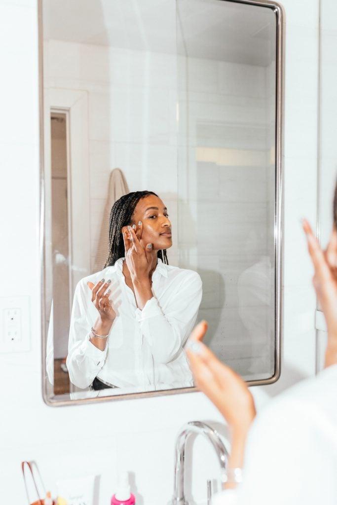 Shanika Hillock applying skincare products