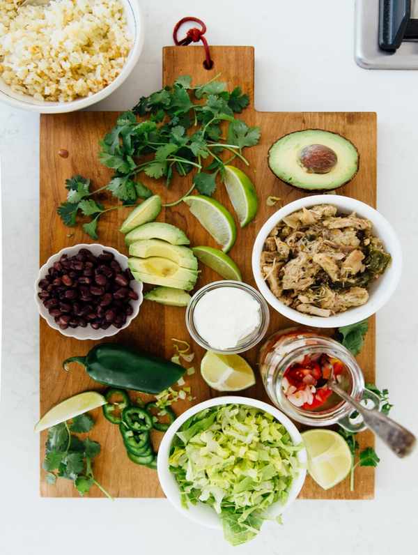 slow cooker burrito bowl ingredients on serving tray