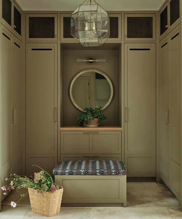 Sage green boot room with built in cabinetry