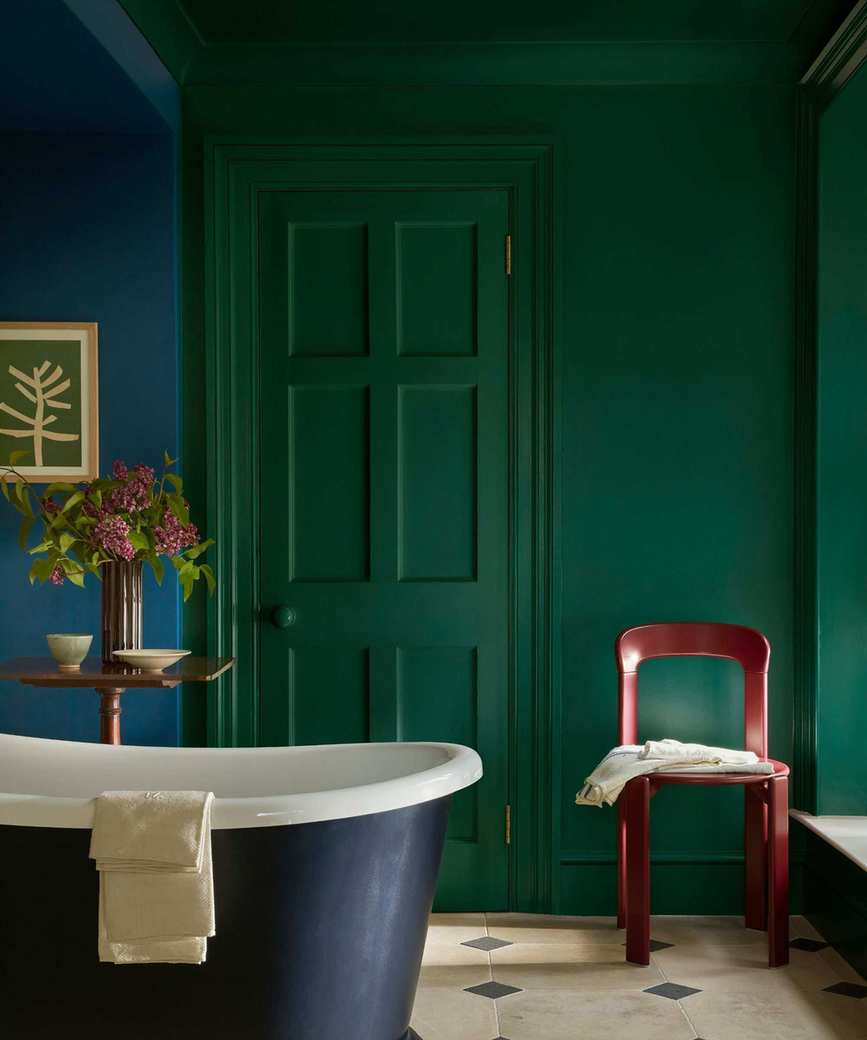 A vibrant blue and green bathroom with a clawfoot tub