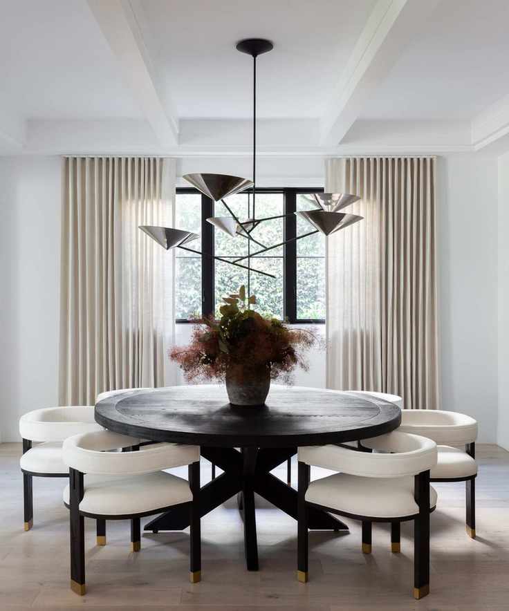 Dining room with black round table and white chairs