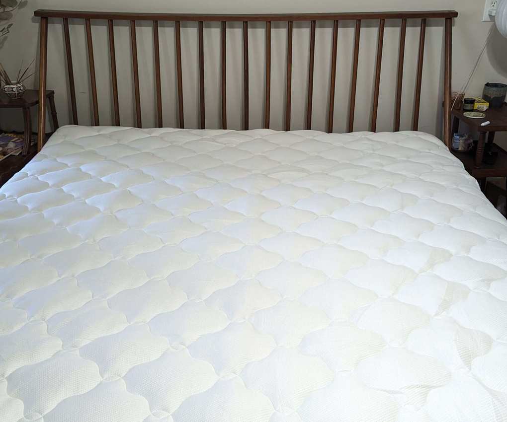 Helix Plush Mattress Topper on a bed.