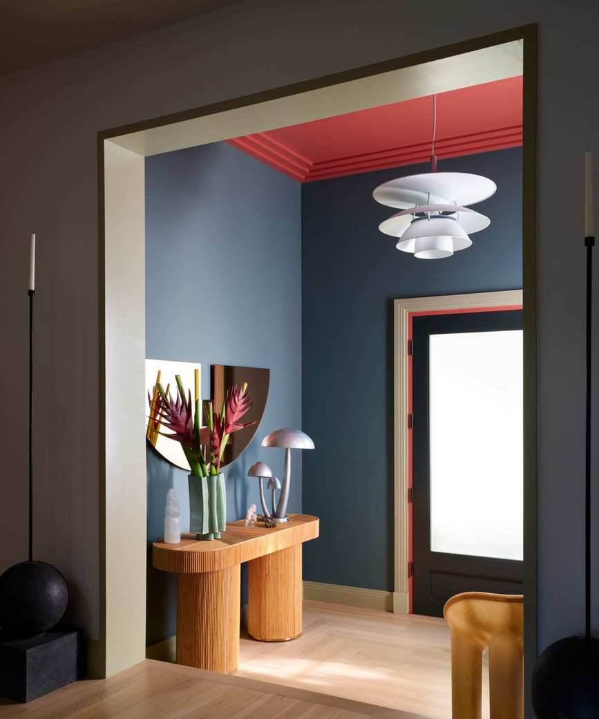 Dark blue entryway with wooden console