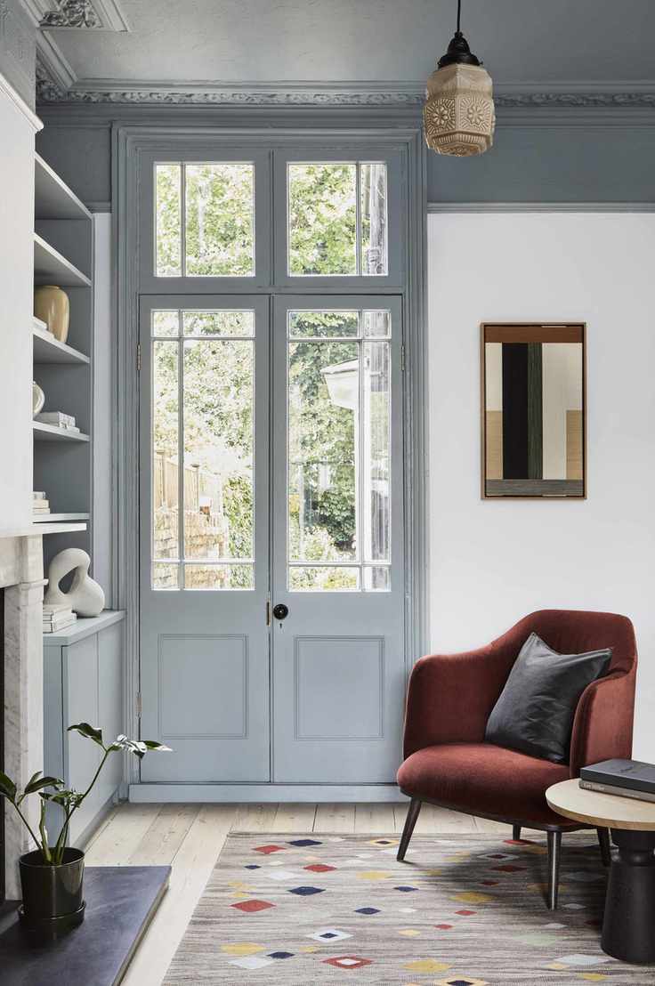 Grey door and ceiling, red velvet armchair