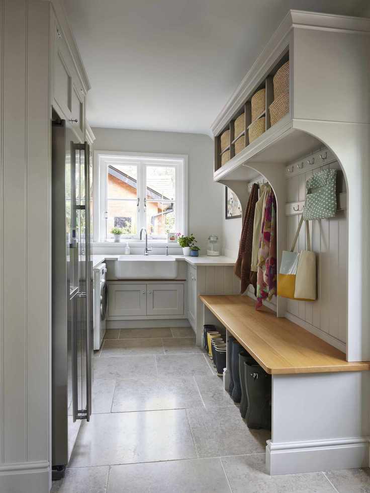 Bright utility room featuring a sink and wooden bench