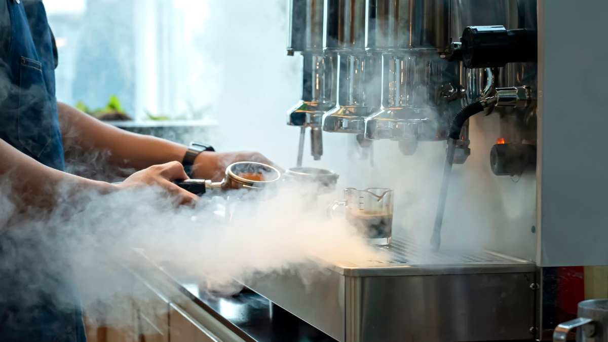 A coffee machine pouring out steam